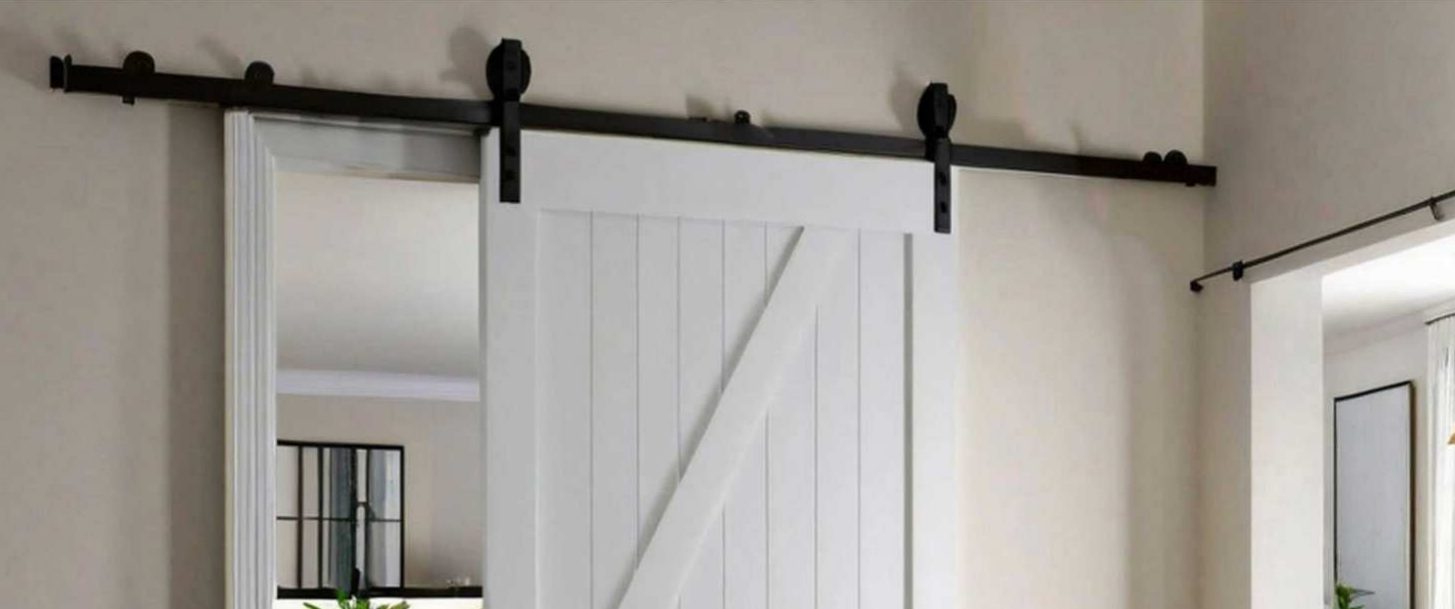 White Z-brace barn door hung on a black sliding track