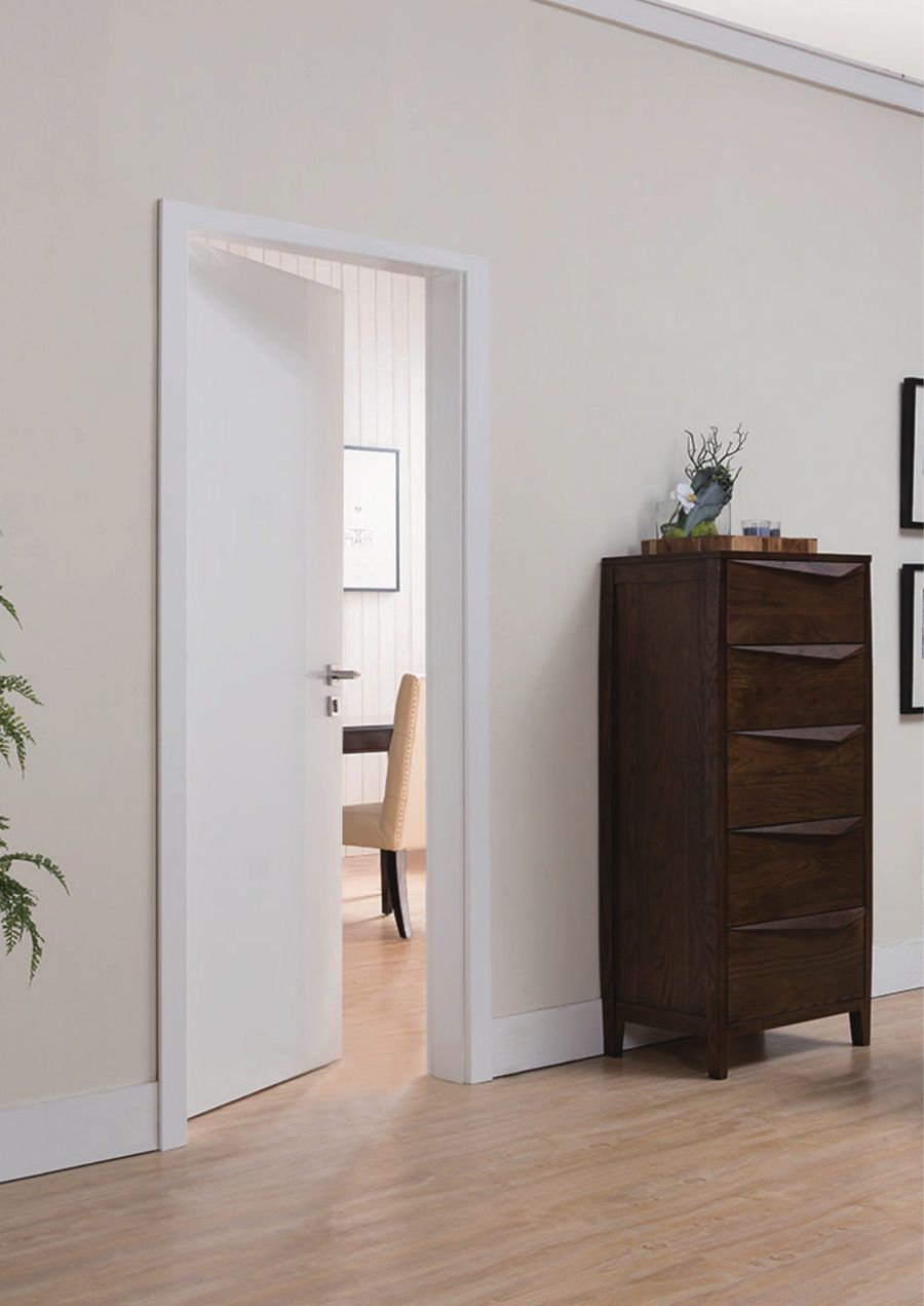 Prehung white interior door open to a hallway